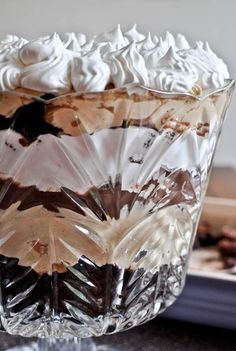 a glass bowl filled with whipped cream and chocolate