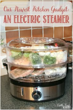 an electric steamer with broccoli and other foods in it on a kitchen counter