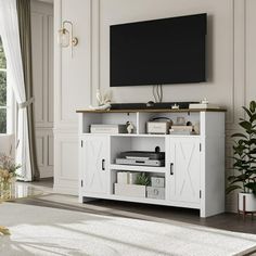 an entertainment center with a flat screen tv mounted on it's wall, in a living room