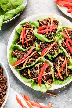 lettuce wraps filled with ground beef and sliced red bell peppers on top of the lettuce leaves