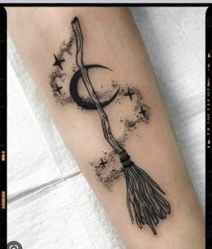 a black and white photo of a tatoo on the arm with stars around it