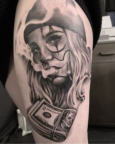 a woman's leg with a tattoo on it and money in her hand,