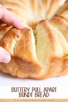 a person holding a piece of bread in front of it's crusty bun