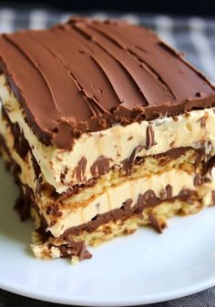 two pieces of cake sitting on top of a white plate with chocolate and cream frosting