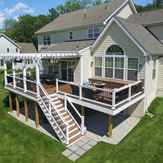 an aerial view of a house with deck and pergolated area in the front yard