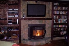 a living room with a fire place and bookshelves