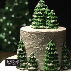 a white cake with green frosting and trees on top