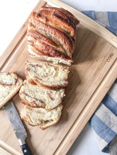 sliced bread sitting on top of a cutting board next to a knife