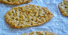 some cookies are sitting on wax paper and ready to be eaten