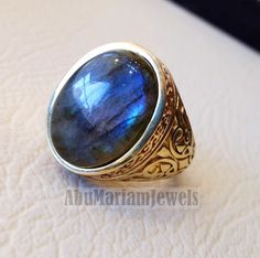 10k yellow gold men ring natural flashy blue labradorite cabochon stone all sizes Ottoman signet style fine jewelry fast shipping gold : 10 k gold Approximate Total ring weight : 9 - 11 gram Stone size : 18 mm X 13 mm stamped 10K Nice gift box included . certificate invoice from our shop of weight and gold purity . Risk free Quality guarantee policy : If you are not satisfied with your item for any reason simply send it to us and you will get a replacement or refund . Note that stone stripes may Gold Men Ring, Labradorite Cabochon, Men Ring, Blue Labradorite, 10k Gold, Custom Rings, Labradorite, Gold Jewelry, Gemstone Rings