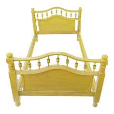 a yellow bed frame with wooden posts and spindles on the headboard, against a white background