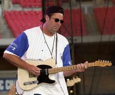 a man playing an electric guitar on stage