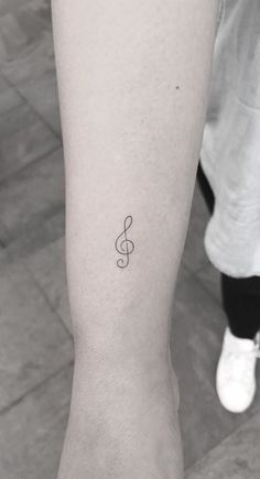 a small musical note tattoo on the ankle