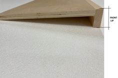 the corner of a piece of plywood is shown with measurements for the top and bottom