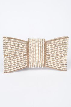 Intricate pearl and bead detailing Bow-shaped design for a bold look Magnetic flap closure Ideal for Dressed up Night Out 10.75"W x 6"H x 1"D Polyurethane/ Rhinestone, Mixed Metal Introducing this luxurious beaded clutch that doubles as a statement accessory. Adorned with intricate pearl and bead detailing, this clutch is shaped like an elegant bow, perfect for adding glamour to evening or formal wear. Its structured design ensures it stands out, while the magnetic flap closure keeps your essent Glamorous Clutch With Pearl Embroidery, Gold Pearl Clutch For Parties, Party Embellished Pearl Evening Bag, Gold Pearl Party Clutch, Party Gold Pearl Clutch, Party Clutch With Pearl Embroidery In Gold, Gold Clutch With Pearl Embroidery For Party, Party Gold Clutch With Pearl Embroidery, Pearl Embroidered Party Clutch