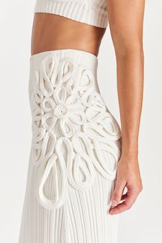 Designed in a sliming, vertical ribbed knit, this mid-length skirt is balanced by intricate and dimensional knit floral detailing at the sides. The high waistband offers easy wear and coverage. Textil Design, Crochet Cover Up, Moda Boho, Knit Skirt, Custom Dresses, Lifestyle Brand, Fashion Details, The High