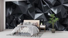 a bedroom decorated in black and white with geometric wallpaper