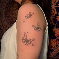 a woman's shoulder with three butterflies on it