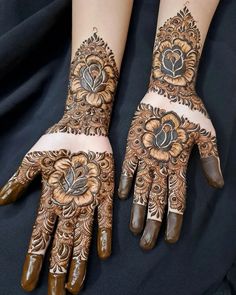 two hands with henna designs on them