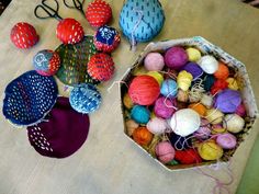 there are many balls of yarn on the table