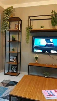 a living room filled with furniture and a flat screen tv mounted on a wall above a wooden coffee table