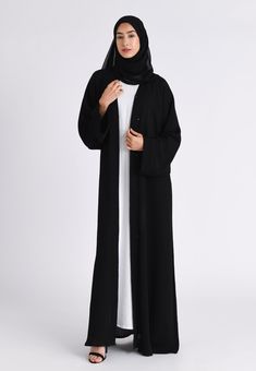 Our simple and elegant plain black textured open abaya is perfect for everyday wear. A perfect essential piece for every wardrobe. Style it with our Inner slips (sold separately). The abaya features pop up buttons on the front of the abaya and the inner sleeves allowing you to style the abaya at your comfort. Made with the high grade textured material. Includes matching belt and chiffon hijab to complete the modest look. This Classic Black Textured Open abaya can be worn on any occasion. Ready to Dispatch Made with high grade textured polyester fabric Hijab & belt included Ideal for Ramadan / Hajj, Umrah & daily wear Solid Color Maxi Length Abaya For Work, Solid Maxi Length Abaya For Work, Modest Black Abaya For Formal Occasions, Formal Long Solid Abaya, Black Open Abaya, Modest Dress Outfits, Ramadan Prayer, Prayer Dress, Dress Abaya