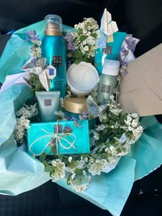 a bouquet of flowers and personal care items are arranged in a circle on blue paper