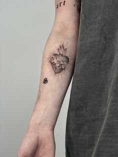 a man with a heart tattoo on his arm