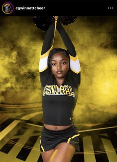 a woman in a cheer uniform is doing a handstand