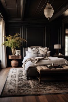 a large bed sitting in a bedroom next to a wooden table with a potted plant on top of it