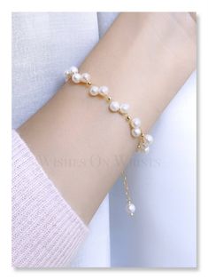 "This bracelet is dainty and elegant. It's perfect for daily wear adding a unique sense to any outfit. It is also a wonderful gift for your family, flower girl, bridesmaids, or best friends.  🤍 Packaging: All jewelry comes in a beautiful and careful packaging. If the item is going directly to the gift recipient please leave us a note during checkout so we don't include the invoice. Material: - Fresh water pearl 5-5.5 mm - 14k gold-plated spacer 2.5mm - 14K gold-plated chain - 14k gold-plated spring ring Your bracelet will arrive in a jewelry box ❖ The pearls are natural, each piece is unique and beautiful so please expect slight variations in color, texture, and size. ❖ The bracelet is made to order, as the bracelet length must be based on your wrist size. The one in the picture is approx Dainty White Bracelets For Bridesmaid Gift, Elegant Beaded Bracelets With Adjustable Chain, Delicate Beaded Bracelet For Anniversary, Feminine Pearl Bracelet For Gifting, Elegant Bracelet Jewelry For Bridesmaid Gift, Elegant Bangle Bracelets For Bridesmaid Gift, Minimalist White Beaded Bracelets For Wedding, Pearl White Bracelet Jewelry As Bridesmaid Gift, Elegant Bangle Jewelry For Bridesmaid Gift