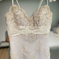 a white wedding dress hanging on a rack