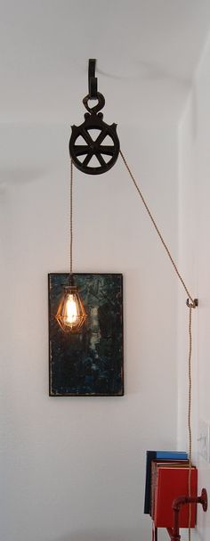 a lamp hanging from the side of a white wall