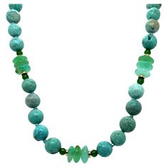 Beautiful greenish blue turquoise is paired with bright chrome diopside and elegant chrysoprase in this pretty necklace that is perfect for all seasons! The 8mm round turquoise has lovely color and subtle veining that gives each bead its own character and beauty. Translucent chrysoprase in shades of tranquil blues and greens complement the softer colors of the turquoise, while bright emerald-hued chrome diopside accentuate the green tones and add eye-catching pops of color. 14k yellow gold accent beads allow this strand to be worn with casual or dressier attire! Wear this necklace with lighter colors in the spring and summer, and with bolder colors in the cooler months. This necklace measures 21 inches and is shown with a matching shorter strand (NCK-1287, 18 inches long), which is sold se Chrysoprase Necklace, 1st Dibs, Pretty Necklace, Artisan Bracelets, Vintage Beads Necklace, Greenish Blue, Pretty Necklaces, Ring Pendant Necklace, Green Tones