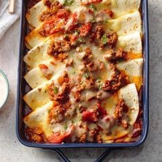 a casserole dish filled with meat and cheese