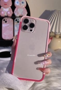 a woman holding up her phone case