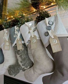 christmas stockings hanging from the fireplace with holiday decorations