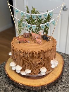 there is a cake that has animals on it and flags in the air above it