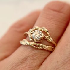 a close up of a person's hand with a ring on it