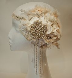 a white mannequin headpiece with flowers and chains