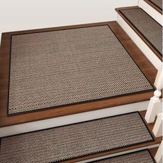 the stair treads are made from wood and have woven carpeting on each step