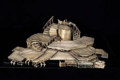 a model of a building made out of wooden planks and slats on a black background