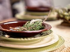 a close up of a plate on a table with other plates and place settings in the background