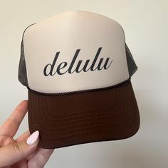 The Delulu Trucker Hat combines style and personality. The mesh back and fully adjustable design provides maximum breathability and a comfortable fit, while the screen printed "Delulu" on the front adds personality. Available in both brown and teal, this hat is the perfect accessory for any adventure. -Fully adjustable snap back -Foam trucker hat Mexico Essentials, Gym Hats, Cricut Hats, Pink Trucker Hat, Hat Bar, Dope Hats, Custom Trucker Hats, Work Gear, Mama Style