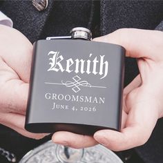 a close up of a person holding a flask with a wedding date on it