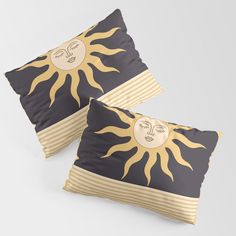 two pillows with sun and moon designs on them