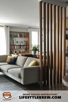 a living room filled with furniture next to a tall book shelf covered in lots of books