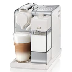 an espresso machine with a cup of coffee next to it