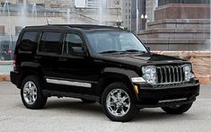 a black jeep parked in front of a fountain