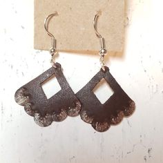 The Jasmine Style is both hand stamped and painted with silver accents. Hand-tooled Brown Earrings For Festival, Brown Hand Tooled Earrings For Festival, Artisan Leather Nickel-free Earrings, Brown Artisan Metal Earrings, Artisan Brown Metal Earrings, Unique Hand Forged Brown Earrings, Artisan Leather Earrings As Gift, Handmade Leather Earrings For Festivals, Artisan Hand Tooled Jewelry